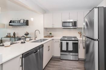 White cabinetry kitchen stainless steel appliances at North Harbor Tower, Chicago, Illinois 60601